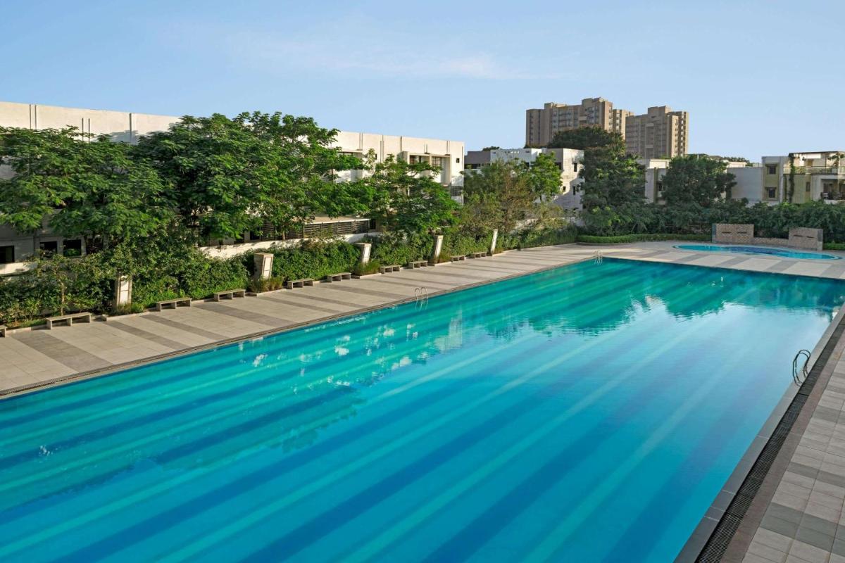 a swimming pool on the roof of a building at Wyndham Ahmedabad Shela in Ahmedabad a swimming pool on the roof of a building at Wyndham Ahmedabad Shela in Ahmedabad