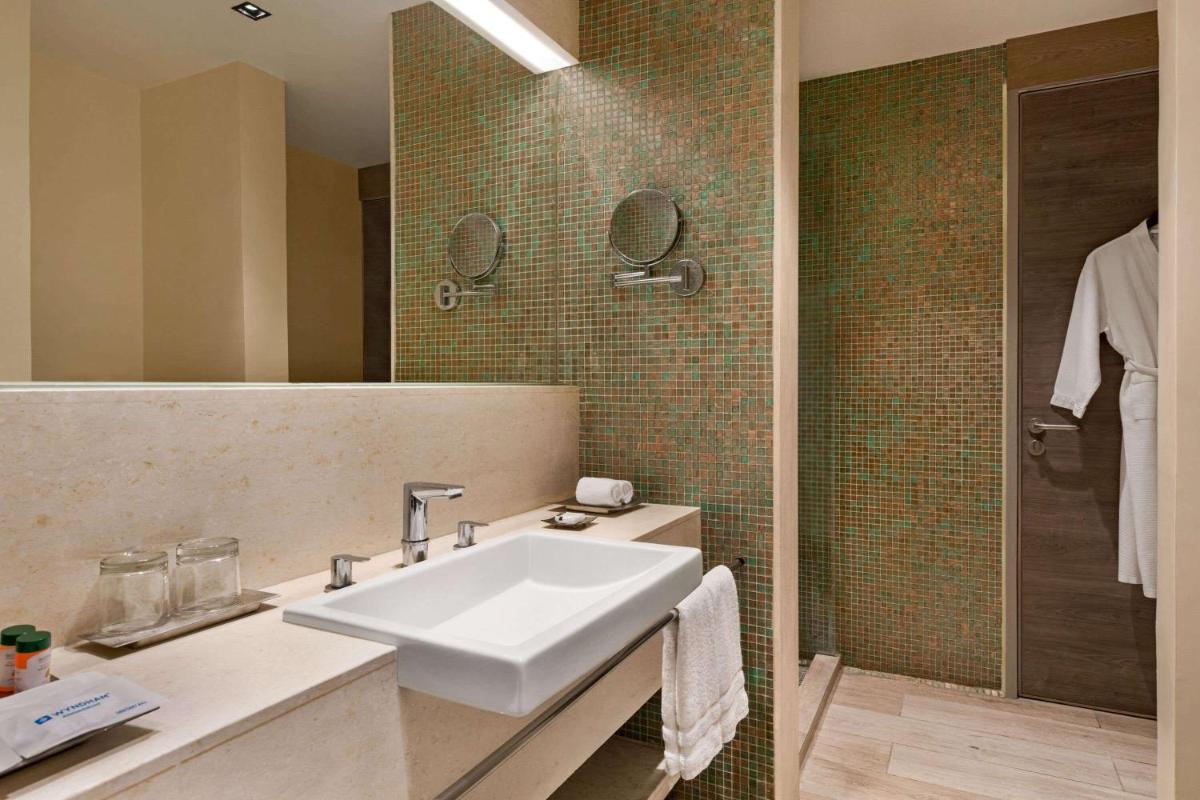 a bathroom with a sink and a shower at Wyndham Ahmedabad Shela in Ahmedabad