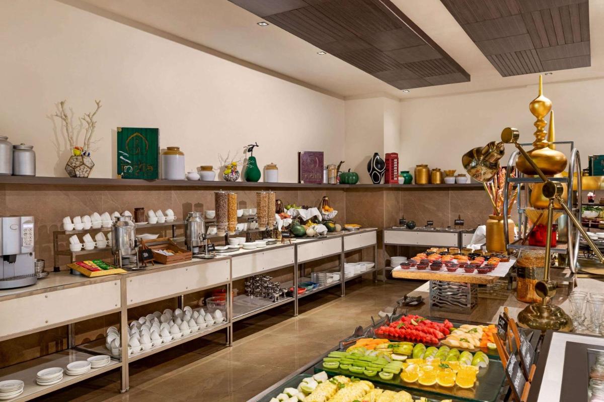a room filled with lots of food on display at Wyndham Ahmedabad Shela in Ahmedabad