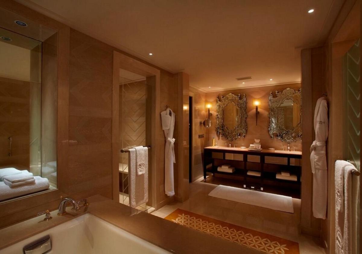 a large bathroom with a tub and a sink at The Leela Palace Udaipur in Udaipur