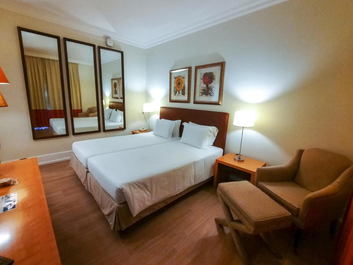 Uma cama ou camas num quarto em Azoris Faial Garden – Resort Hotel