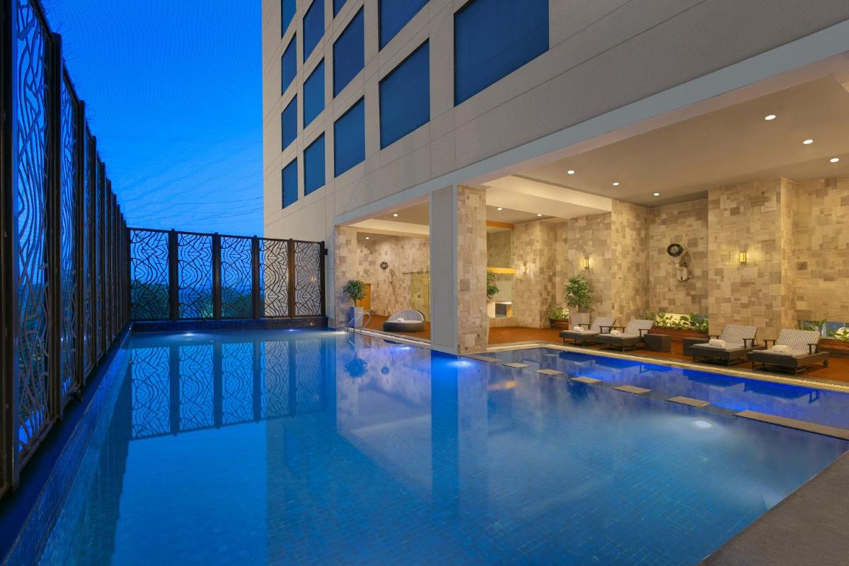 a large swimming pool in a house at Novotel Ahmedabad in Ahmedabad