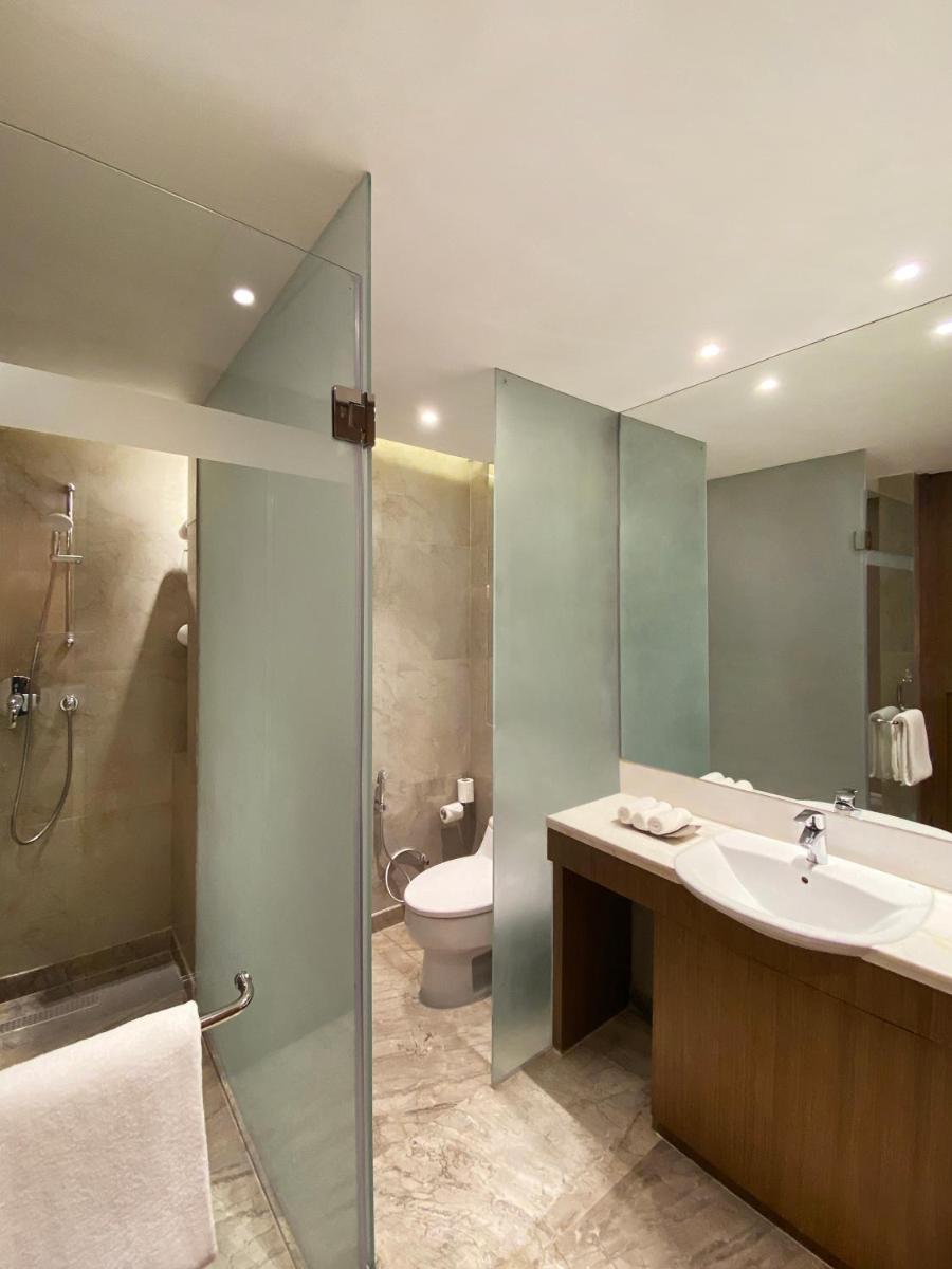 a bathroom with a sink and a toilet and a shower at Radisson Blu Hotel Amritsar in Amritsar
