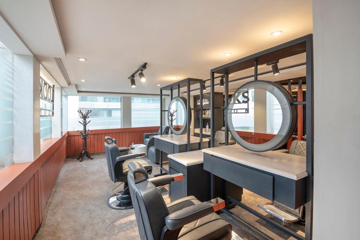 a salon with a row of sinks and mirrors at Radisson Blu Kaushambi Delhi NCR in Ghaziabad