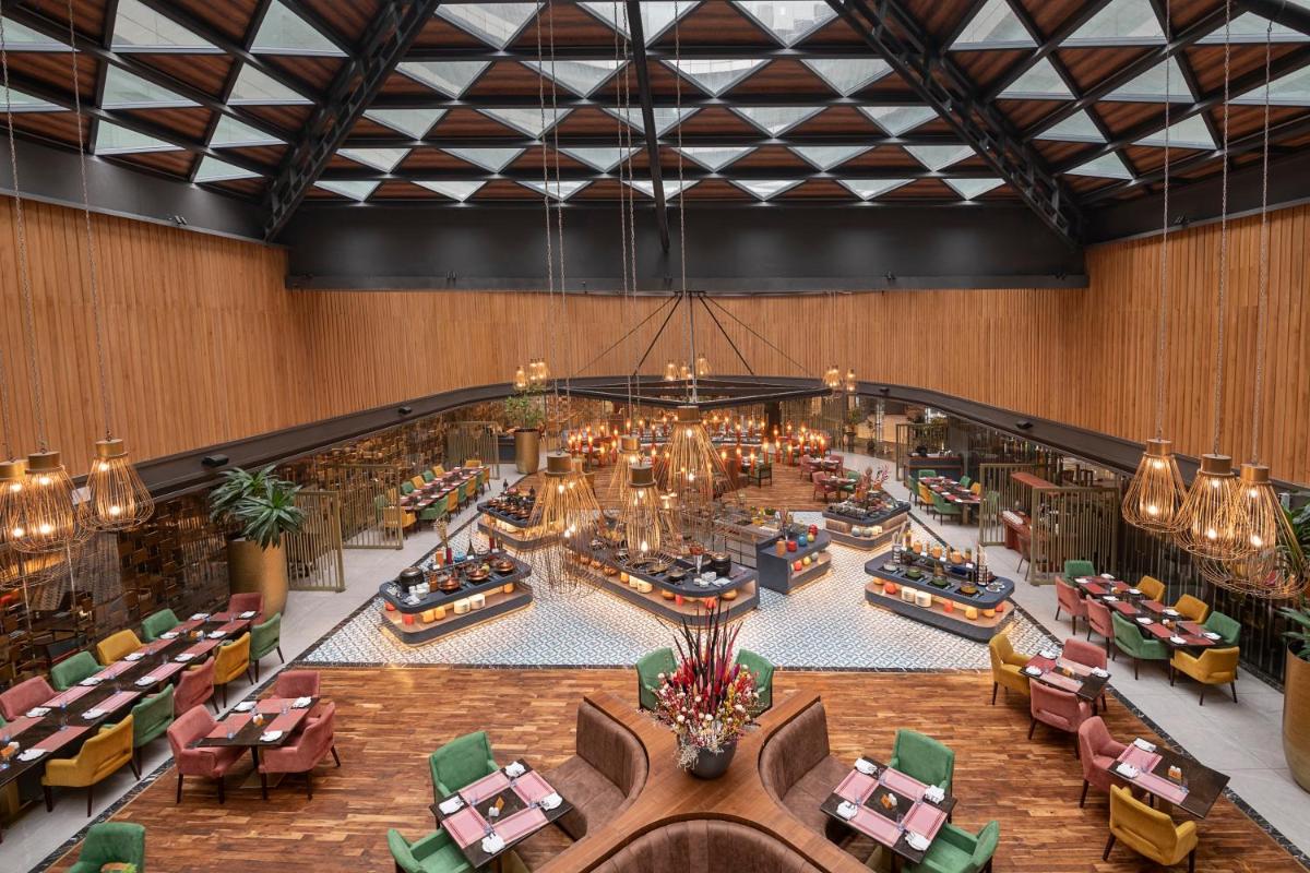 an overhead view of a hotel lobby with tables and chairs at Radisson Blu Kaushambi Delhi NCR in Ghaziabad