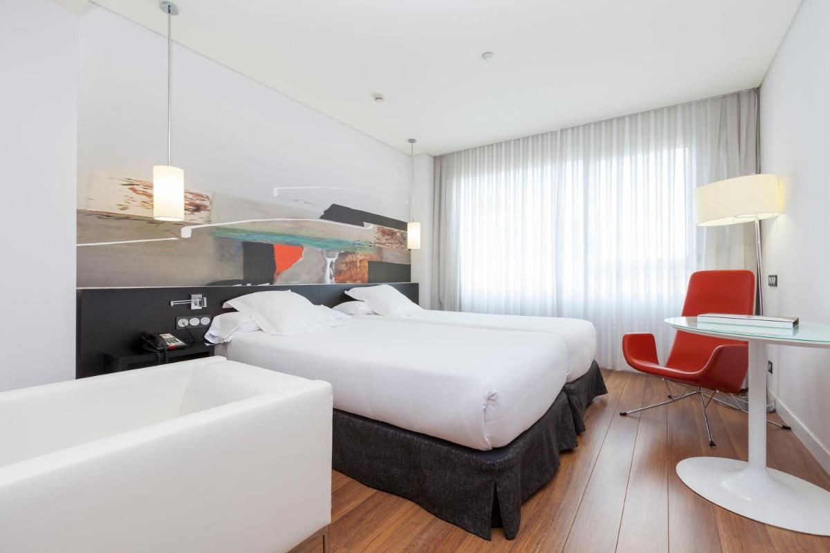 Cama o camas de una habitación en Axor Barajas