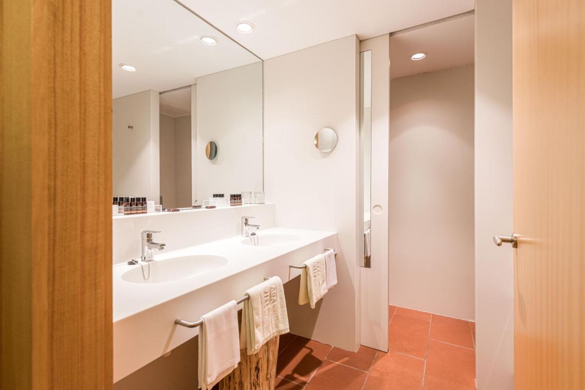 Un baño con dos lavabos y un espejo. en Almadraba Park Hotel, en Roses