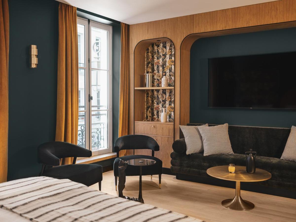 un salon avec un canapé et une table dans l'établissement Dandy Hotel, à Paris