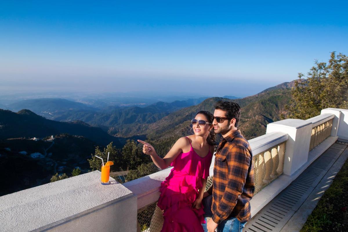 a man and a woman standing on top of a mountain at Jaypee Residency Manor in Mussoorie