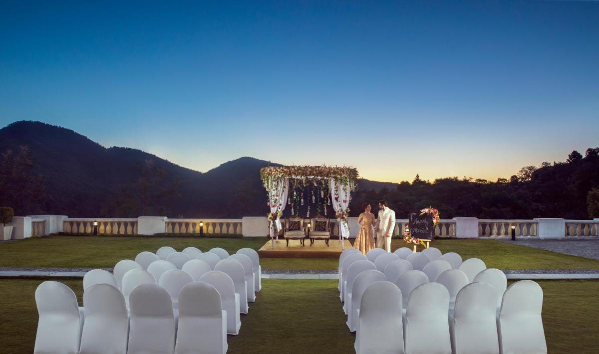 a set up for an outdoor ceremony with white chairs at Jaypee Residency Manor in Mussoorie