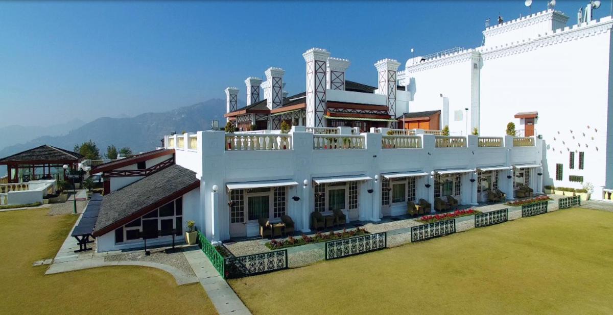 a large white building with a balcony on top of it at Jaypee Residency Manor in Mussoorie