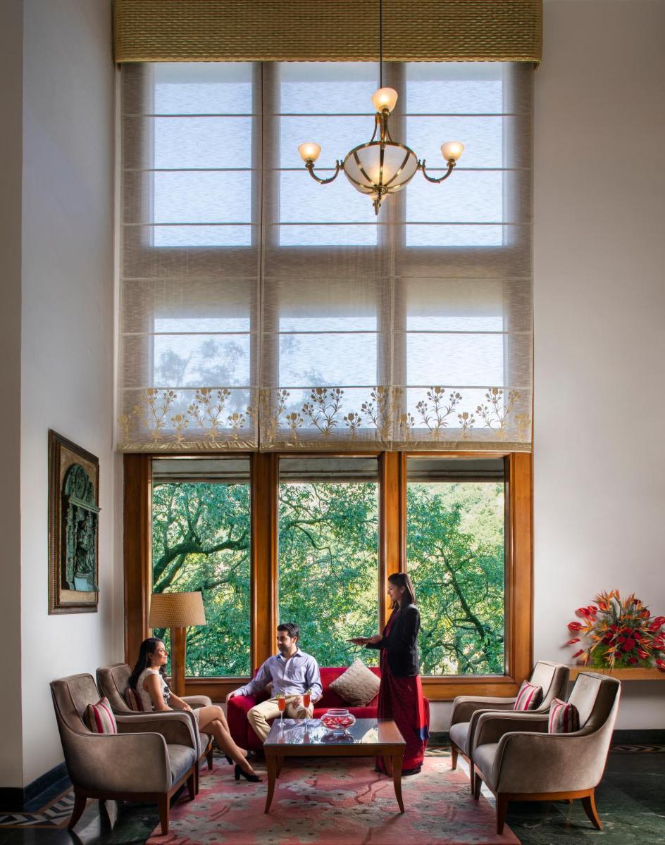 a group of people sitting in a living room with windows at Jaypee Residency Manor in Mussoorie
