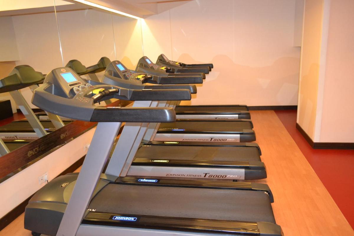 a row of treadmills in a gym at Sayaji Pune in Pune