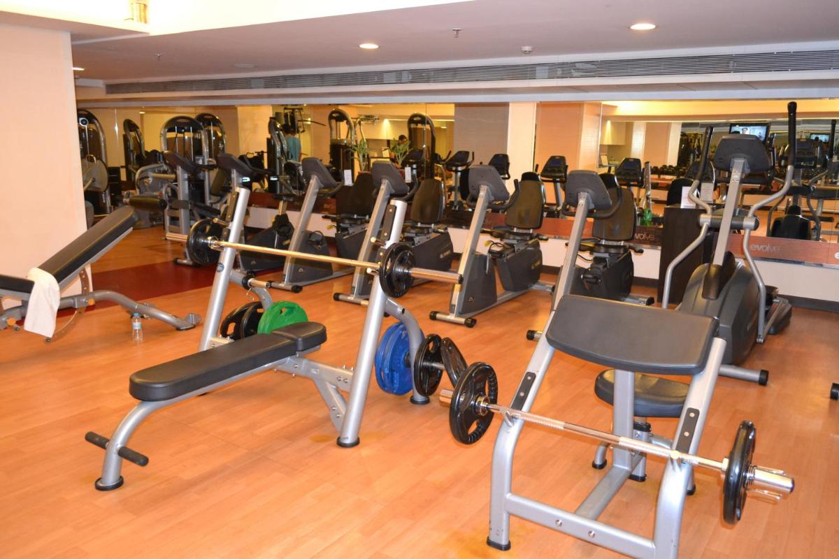 a gym with lots of exercise equipment on the floor at Sayaji Pune in Pune
