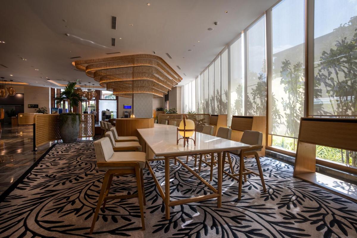 a dining room with a table and chairs at Novotel Hyderabad Airport in Hyderabad