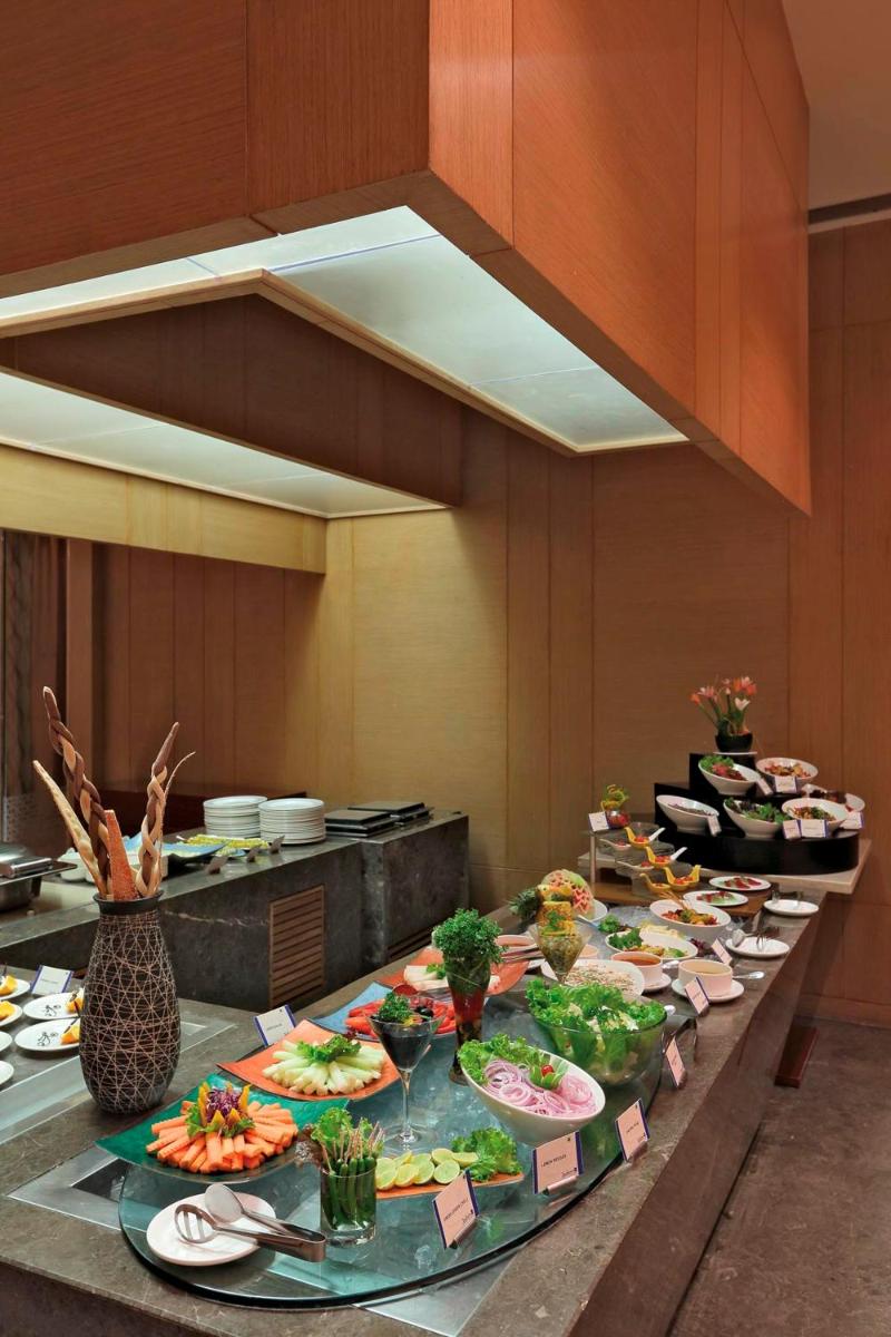 a buffet line with many plates of food on it at Yashail Hotel Haridwar in Haridwār