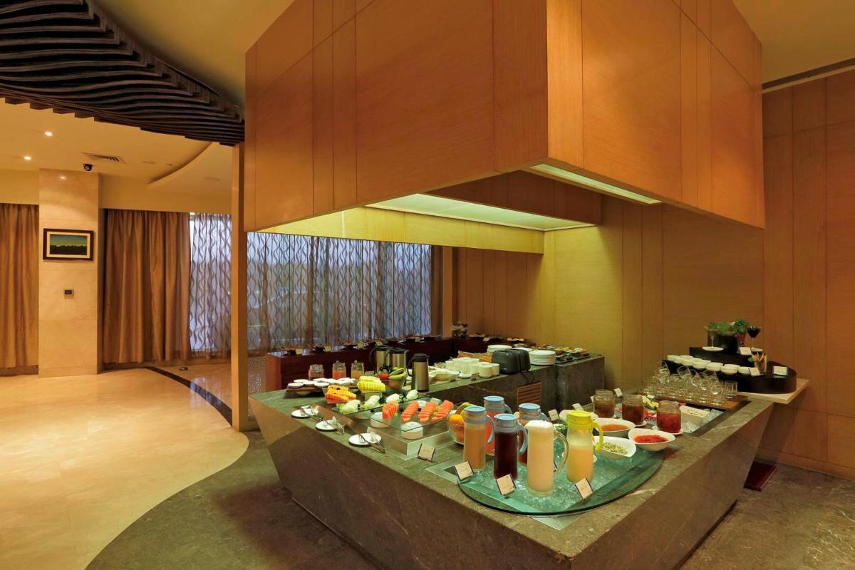 a buffet in a hotel room with food on a table at Yashail Hotel Haridwar in Haridwār