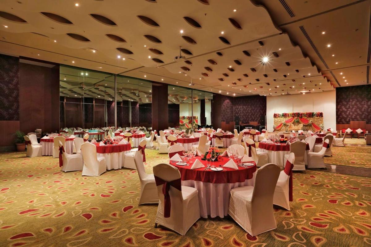 a banquet hall with tables and chairs in a room at Yashail Hotel Haridwar in Haridwār