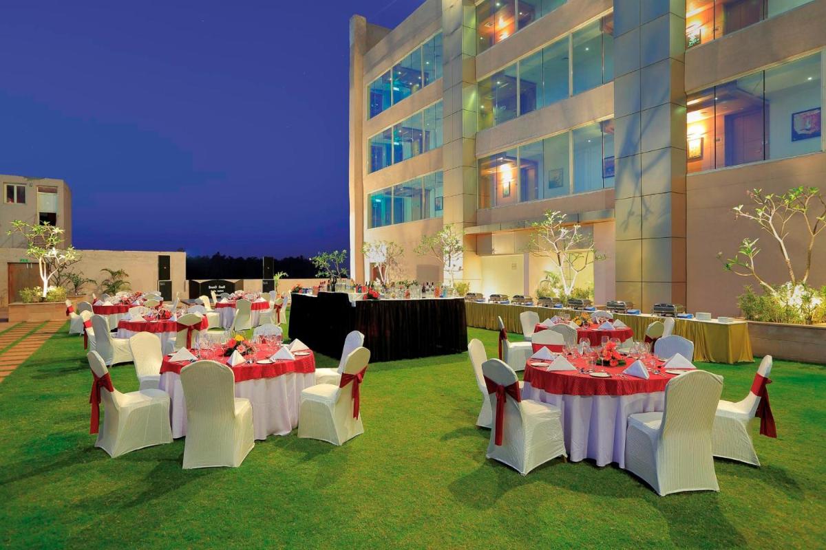 a group of tables and chairs in front of a building at Yashail Hotel Haridwar in Haridwār
