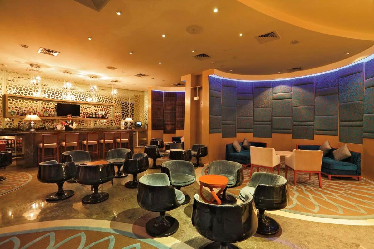 a bar in a hotel with chairs and a counter at Yashail Hotel Haridwar in Haridwār