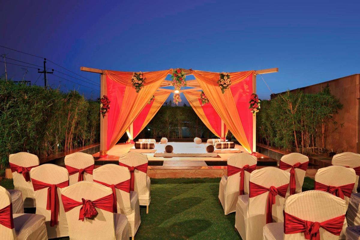 a set up for a wedding with a table and chairs at Yashail Hotel Haridwar in Haridwār