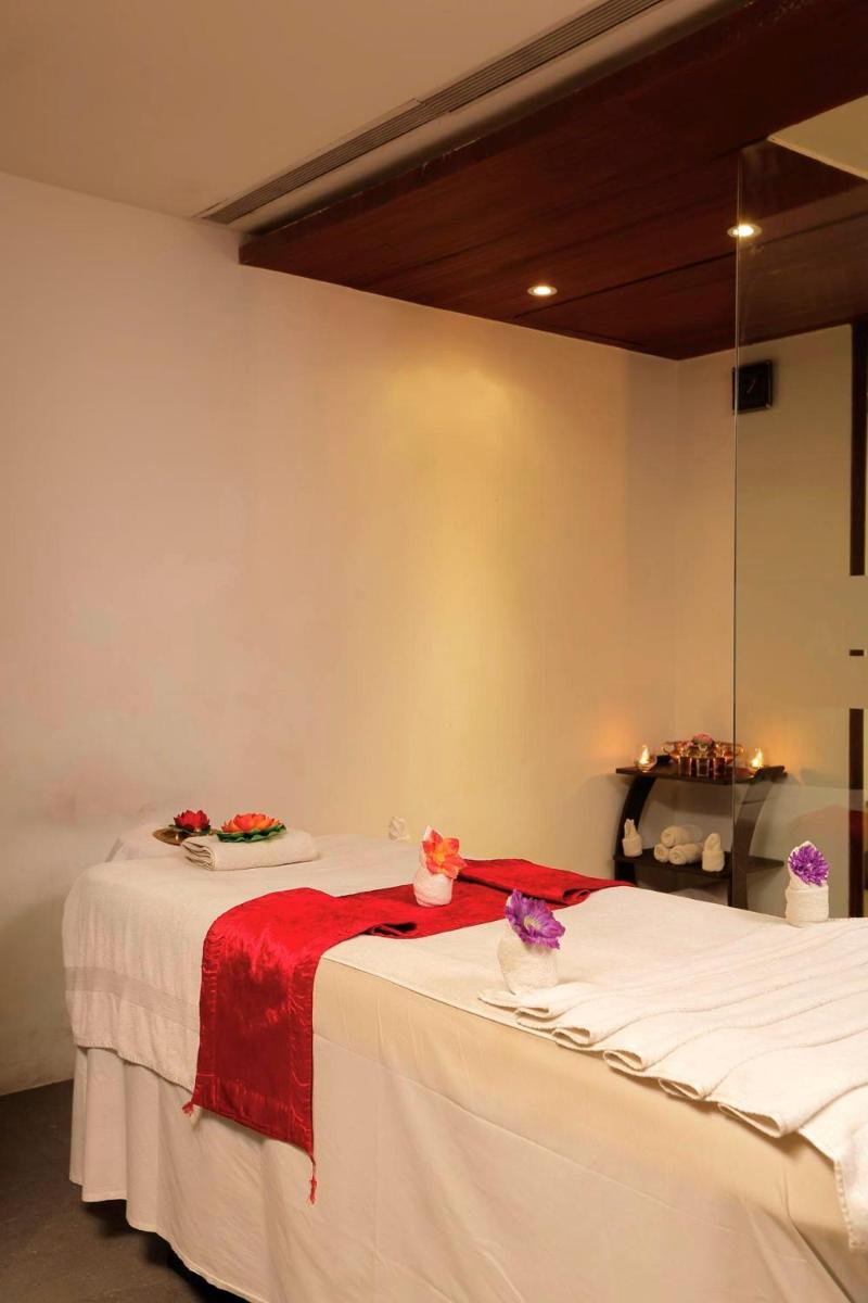 a room with a large bed with a red blanket at Yashail Hotel Haridwar in Haridwār
