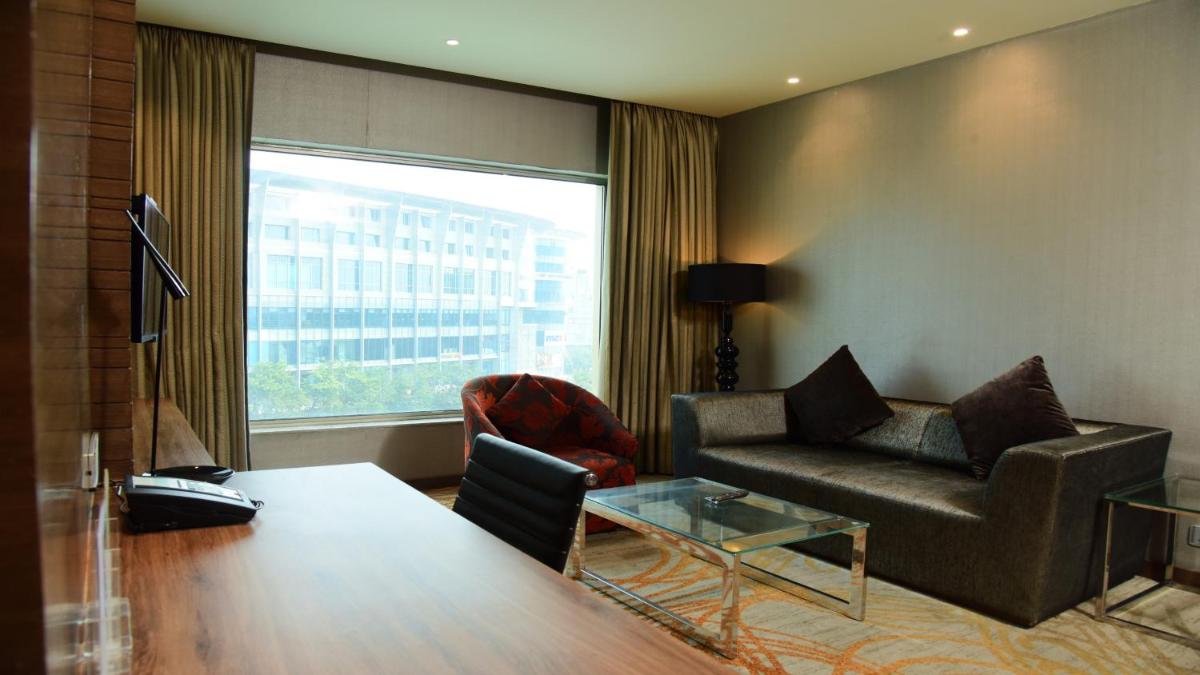 a living room with a couch and a glass table at Holiday Inn Jaipur City Centre by IHG in Jaipur a living room with a couch and a glass table at Holiday Inn Jaipur City Centre by IHG in Jaipur