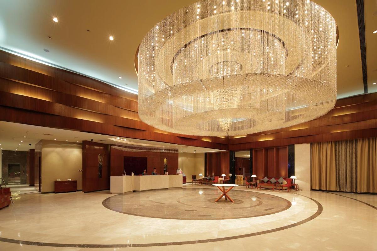 a large chandelier in the lobby of a hotel at Yashail Hotel Haridwar in Haridwār