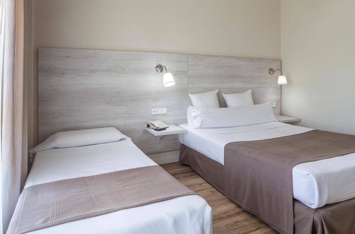 Cama o camas de una habitación en Hotel Jerez & Spa