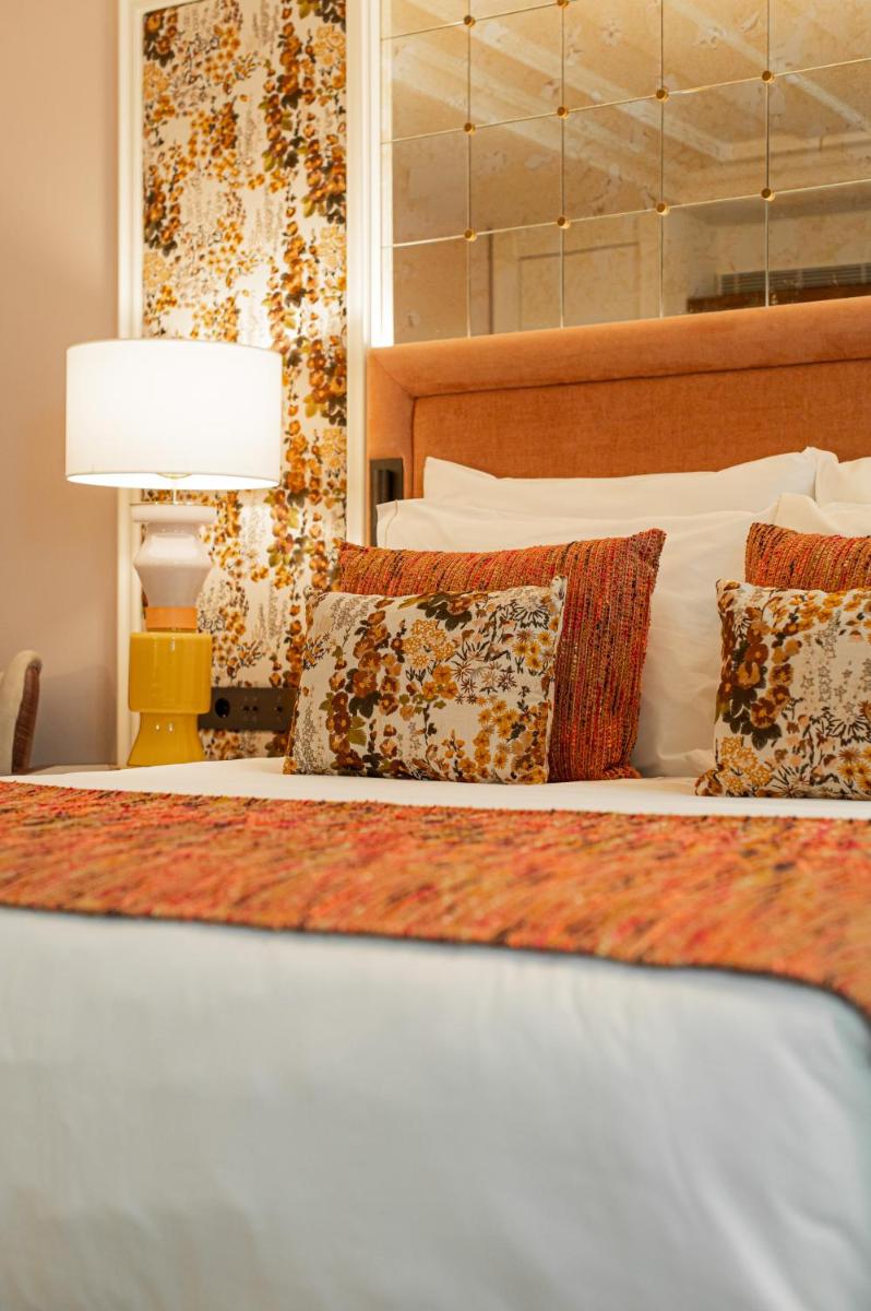 Uma cama ou camas num quarto em Palácio Ludovice Wine Experience Hotel