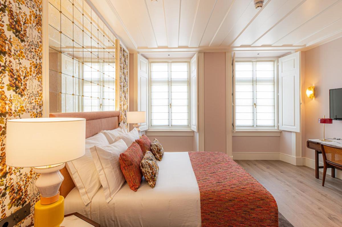 Uma cama ou camas num quarto em Palácio Ludovice Wine Experience Hotel