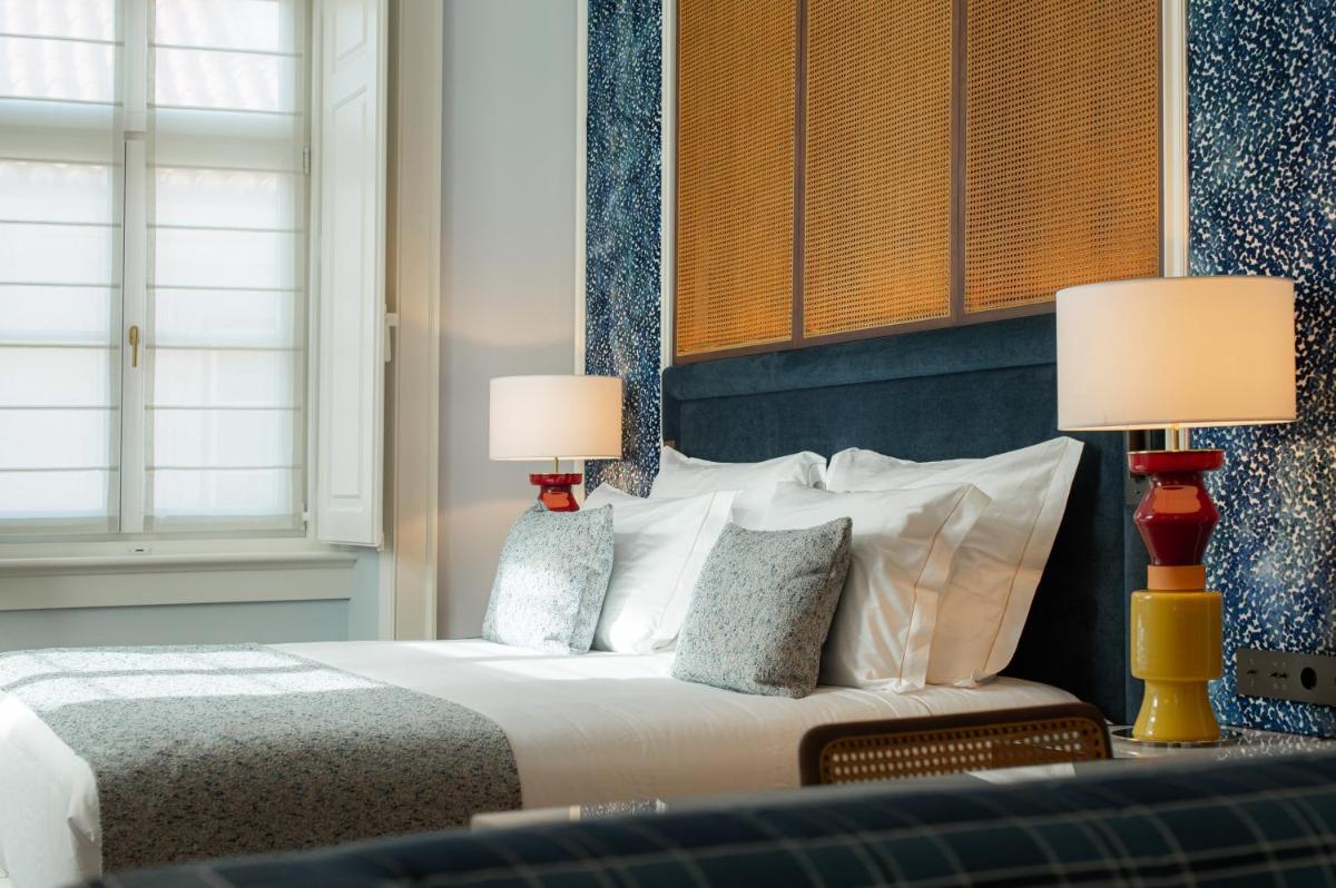 Uma cama ou camas num quarto em Palácio Ludovice Wine Experience Hotel