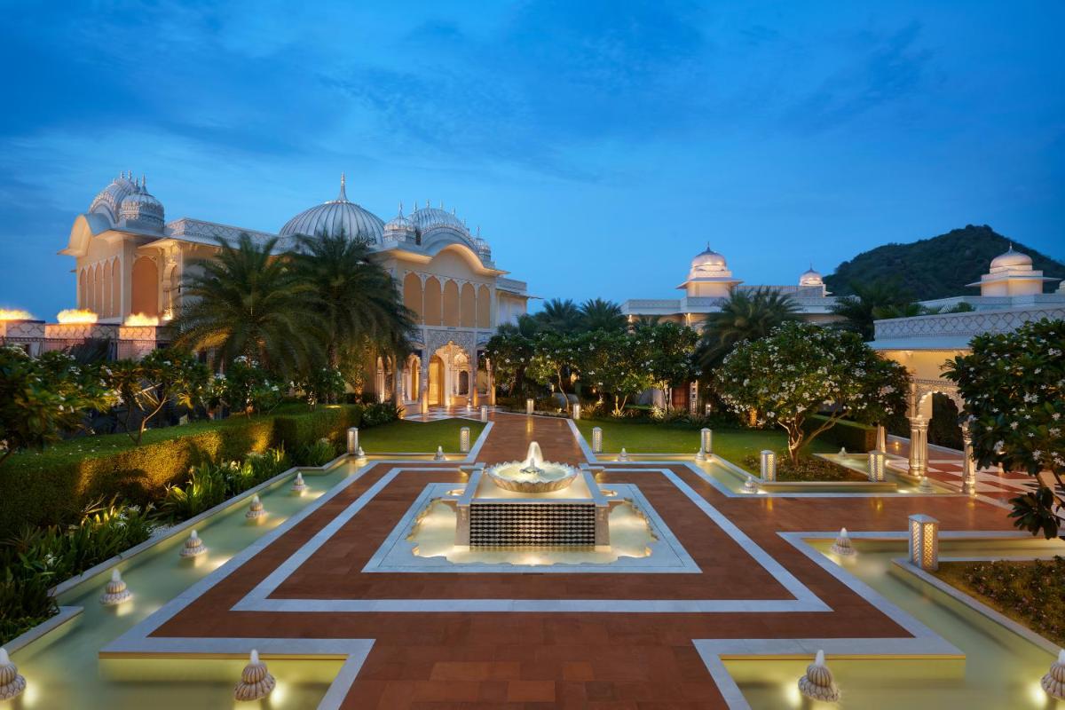 a building with a fountain in the middle of a courtyard at The Leela Palace Jaipur in Jaipur