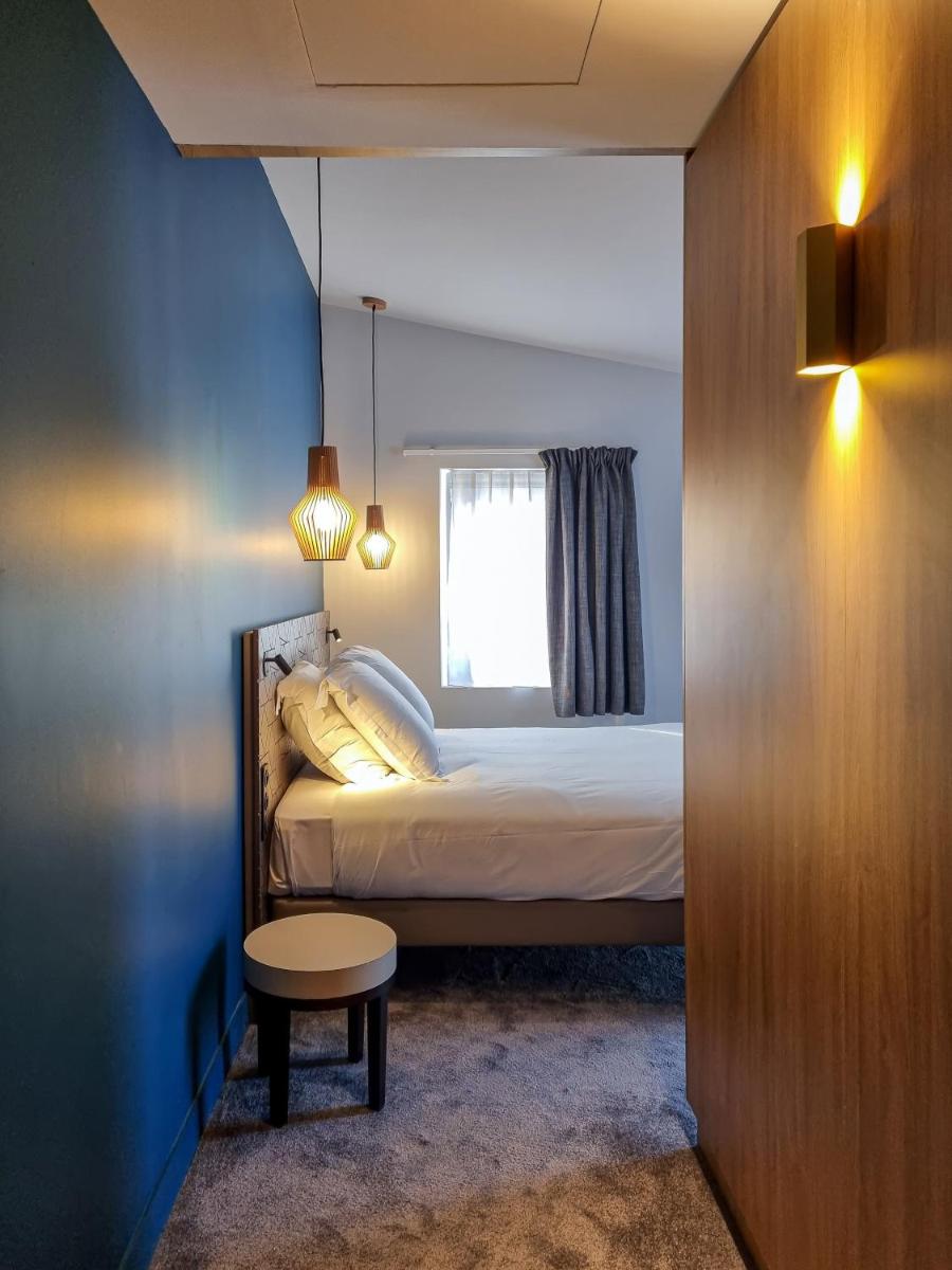 Un ou plusieurs lits dans un hébergement de l'établissement Alex Hotel & Spa