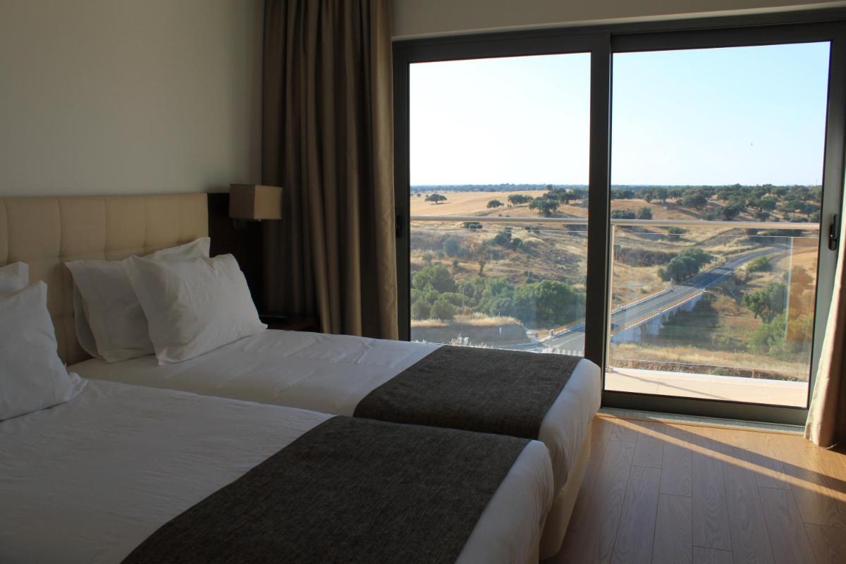 Uma cama ou camas num quarto em Hotel O Gato & Spa