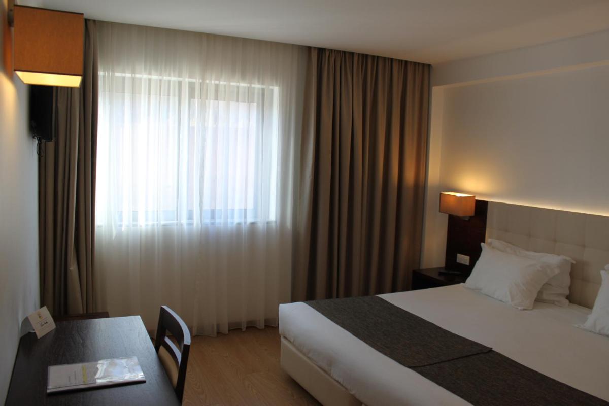Uma cama ou camas num quarto em Hotel O Gato & Spa