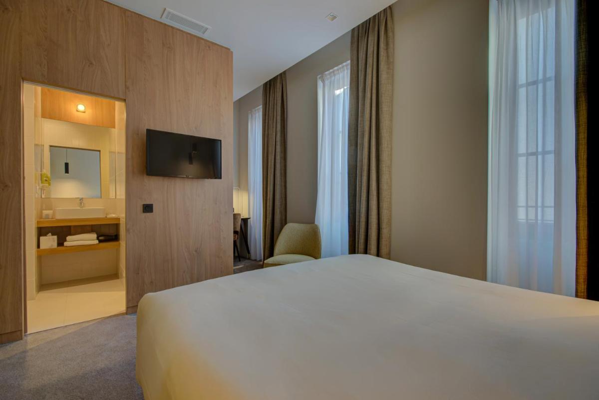 Un ou plusieurs lits dans un hébergement de l'établissement Alex Hotel & Spa