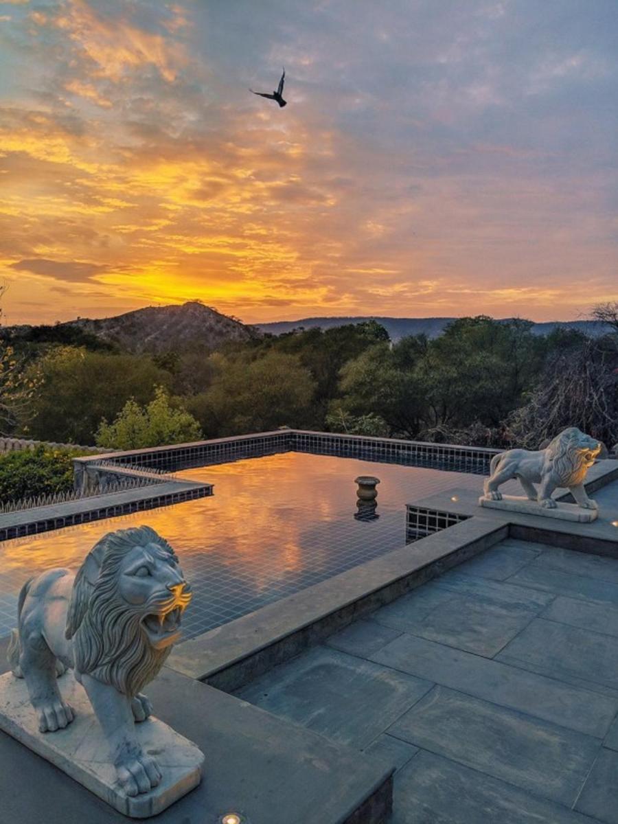 two statues of lions on the roof of a building at Fairmont Jaipur in Jaipur