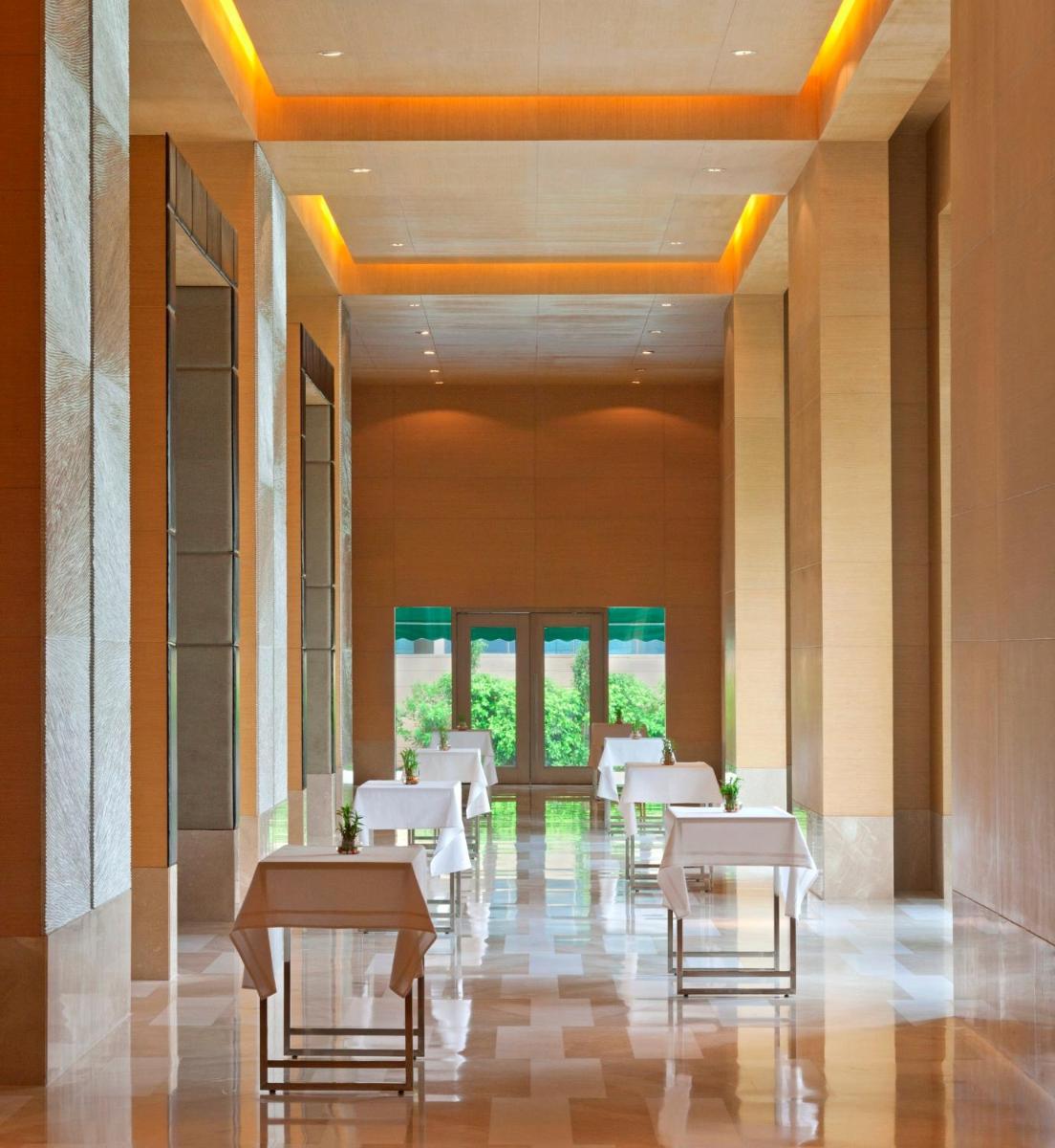 a dining room with white tables and chairs at Radisson Blu Hotel Amritsar in Amritsar