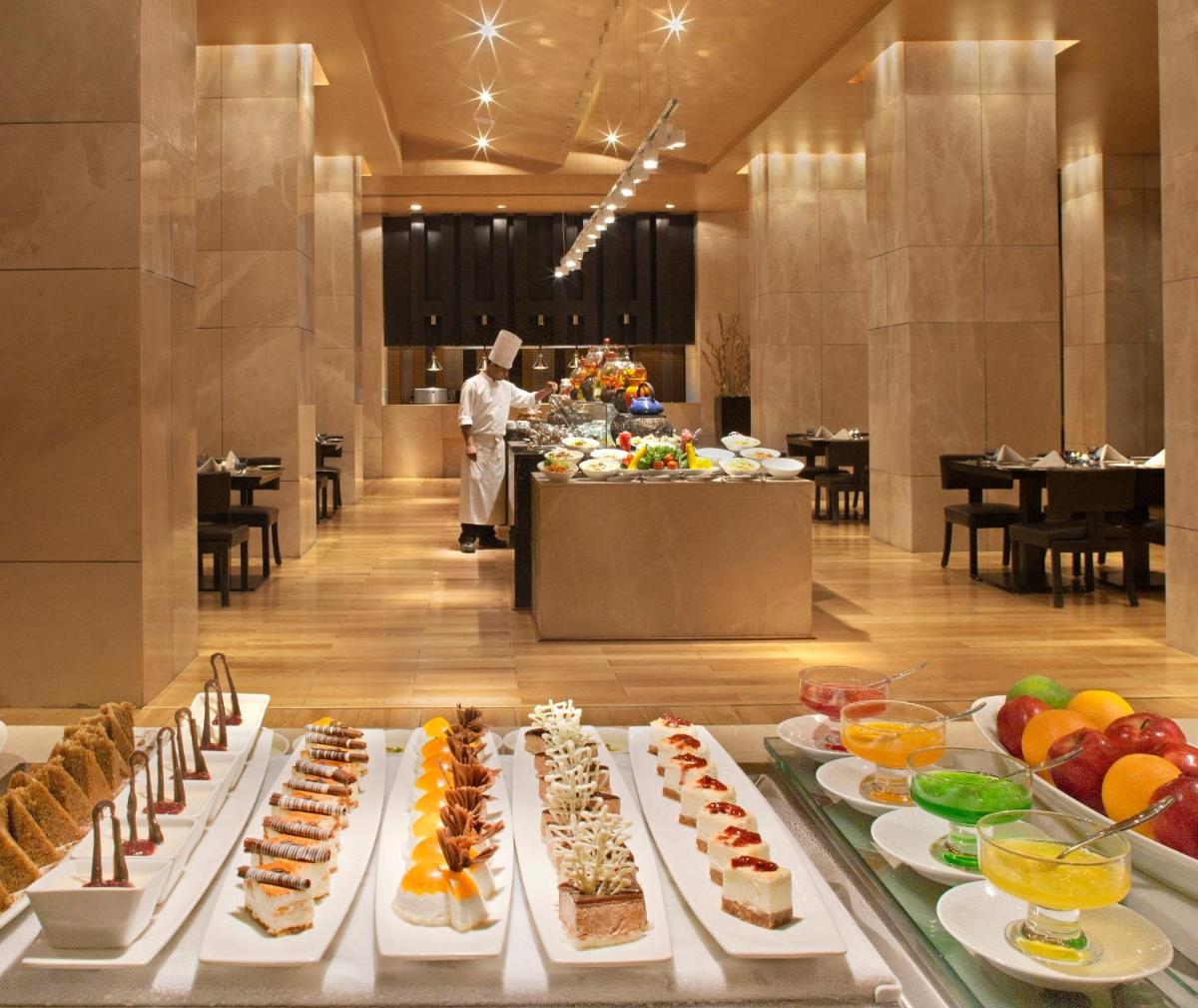 a buffet line of food in a hotel lobby at Radisson Blu Hotel Amritsar in Amritsar