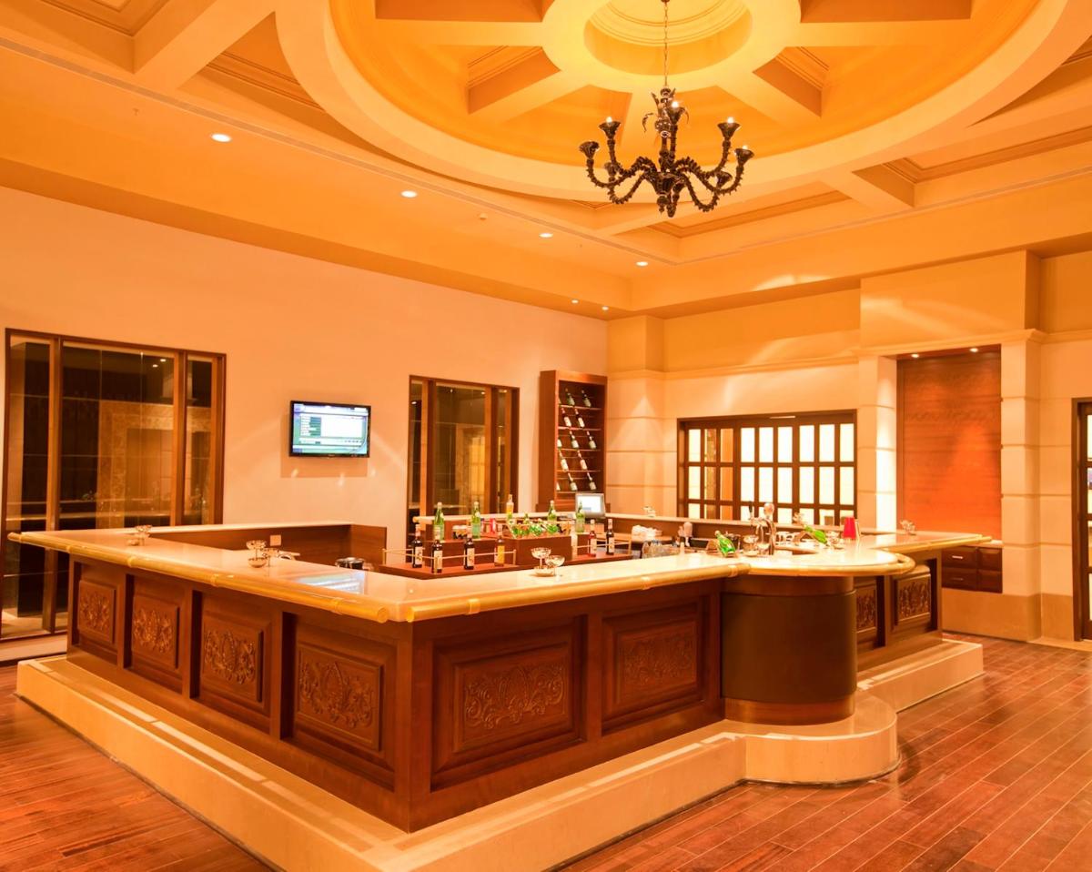 a large bathroom with a large sink with a chandelier at Radisson Blu Hotel Chennai City Centre in Chennai a large bathroom with a large sink with a chandelier at Radisson Blu Hotel Chennai City Centre in Chennai