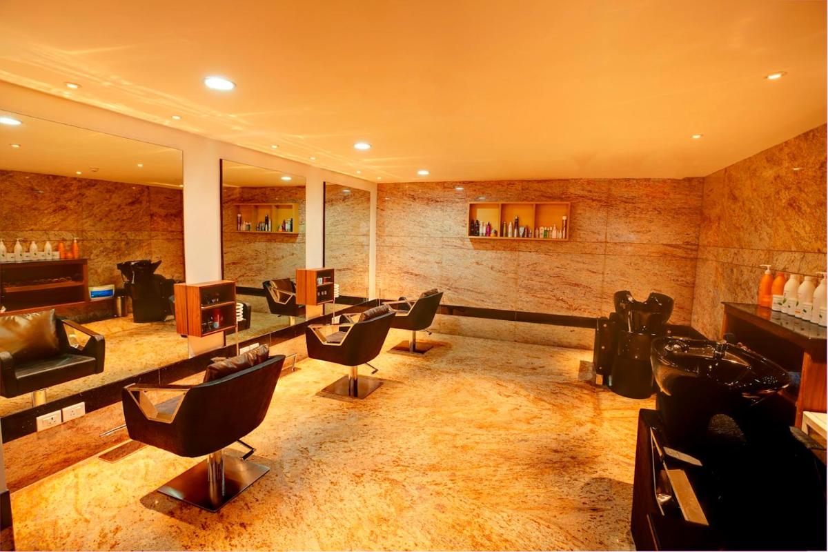 a waiting room with chairs and a hair salon at Radisson Blu Hotel Chennai City Centre in Chennai a waiting room with chairs and a hair salon at Radisson Blu Hotel Chennai City Centre in Chennai