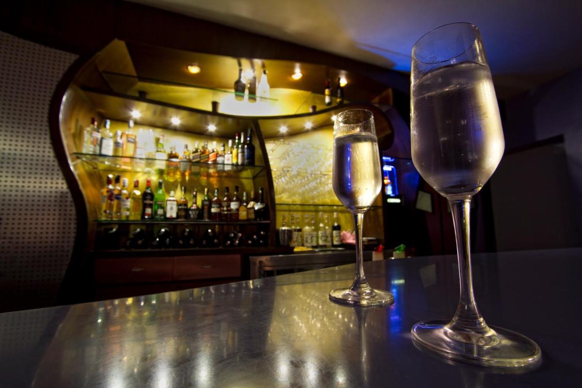 two glasses of water sitting on a bar at The Piccadily in Lucknow