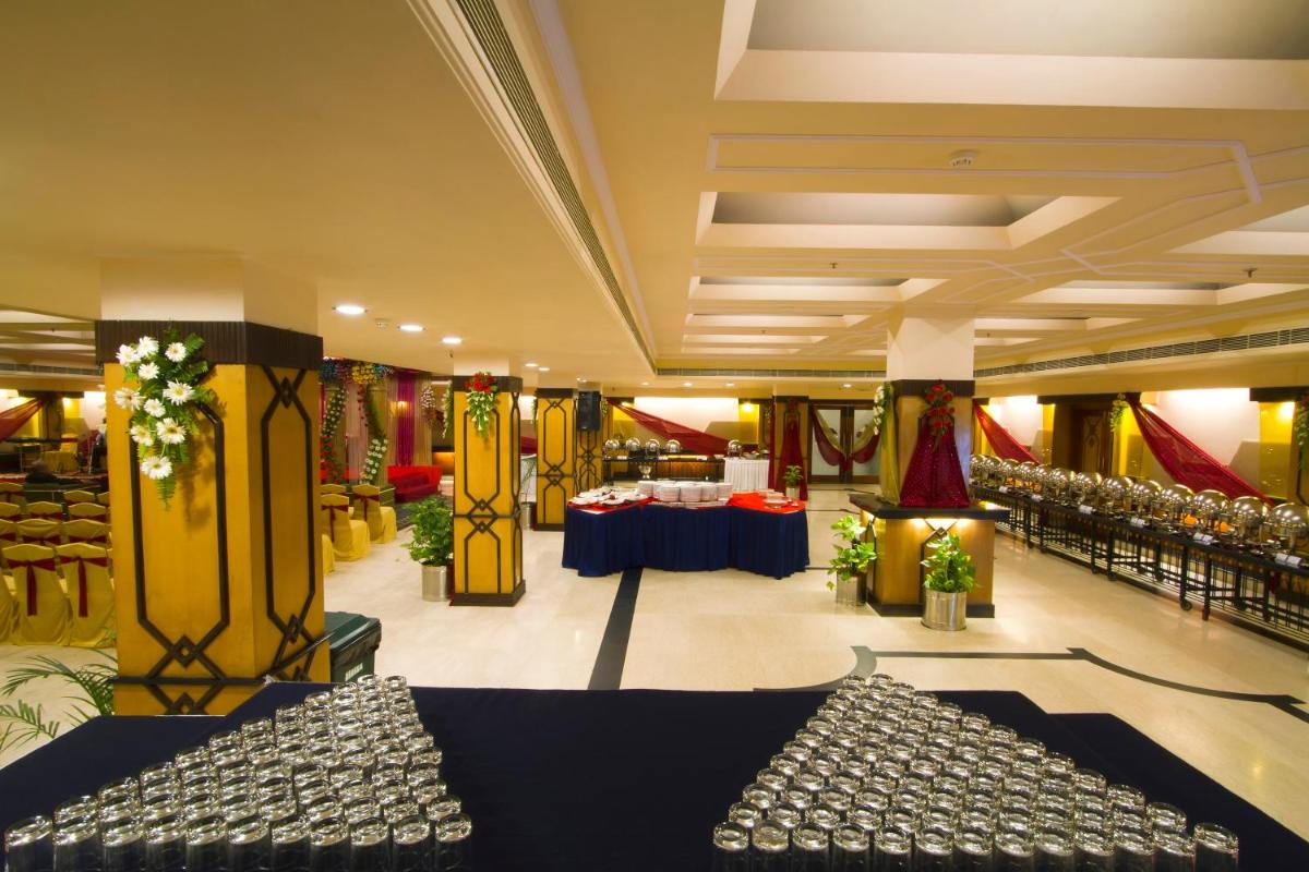 a lobby with couches and tables in a building at The Piccadily in Lucknow