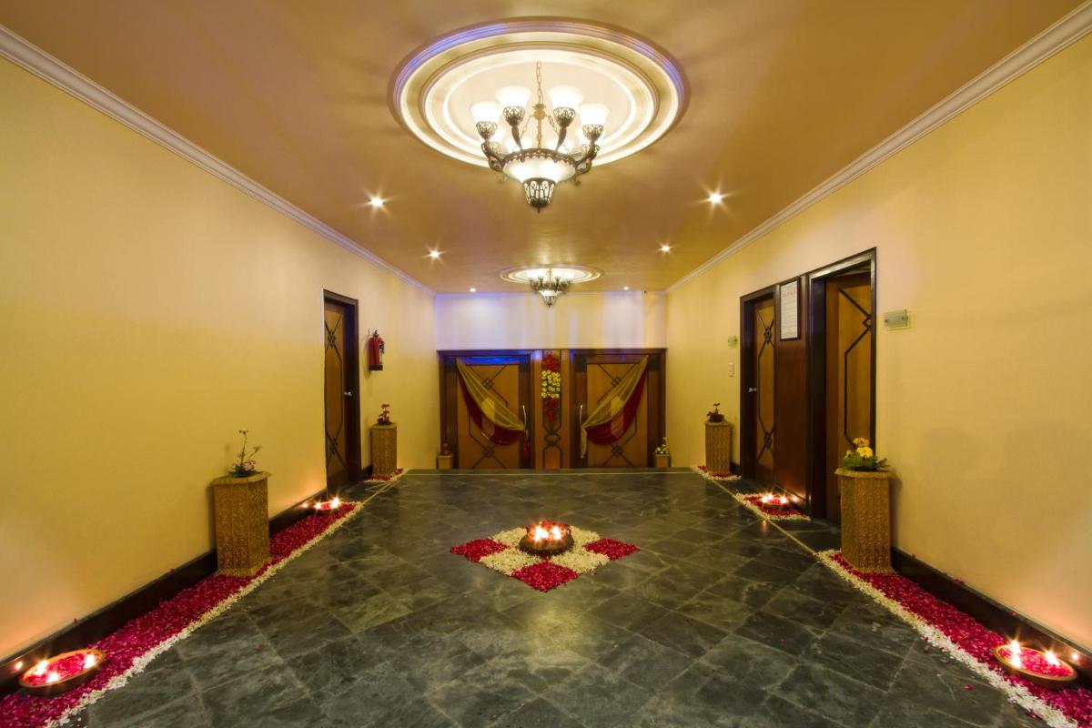 a room with a chandelier and a floor with candles at The Piccadily in Lucknow