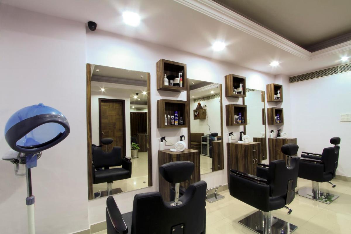 a hair salon with a mirror and a hair dryer at The Piccadily in Lucknow
