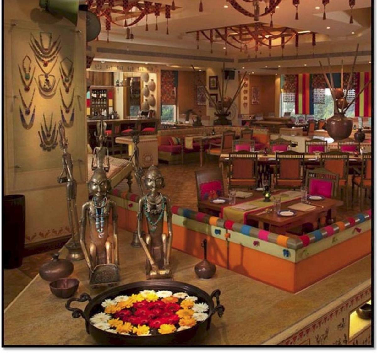 a restaurant with a table with a bowl of flowers at Radisson Blu Hotel, Nagpur in Nagpur