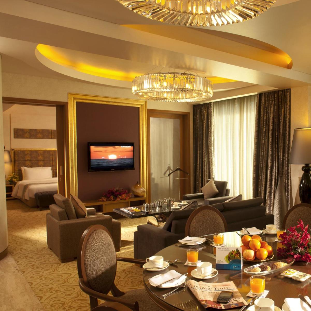 a living room filled with furniture and a chandelier at Radisson Blu Hotel, Nagpur in Nagpur