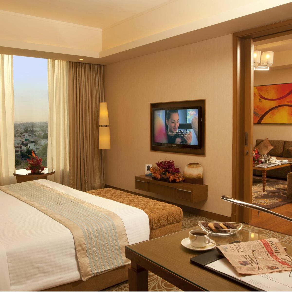 a hotel room with a bed and a tv at Radisson Blu Hotel, Nagpur in Nagpur