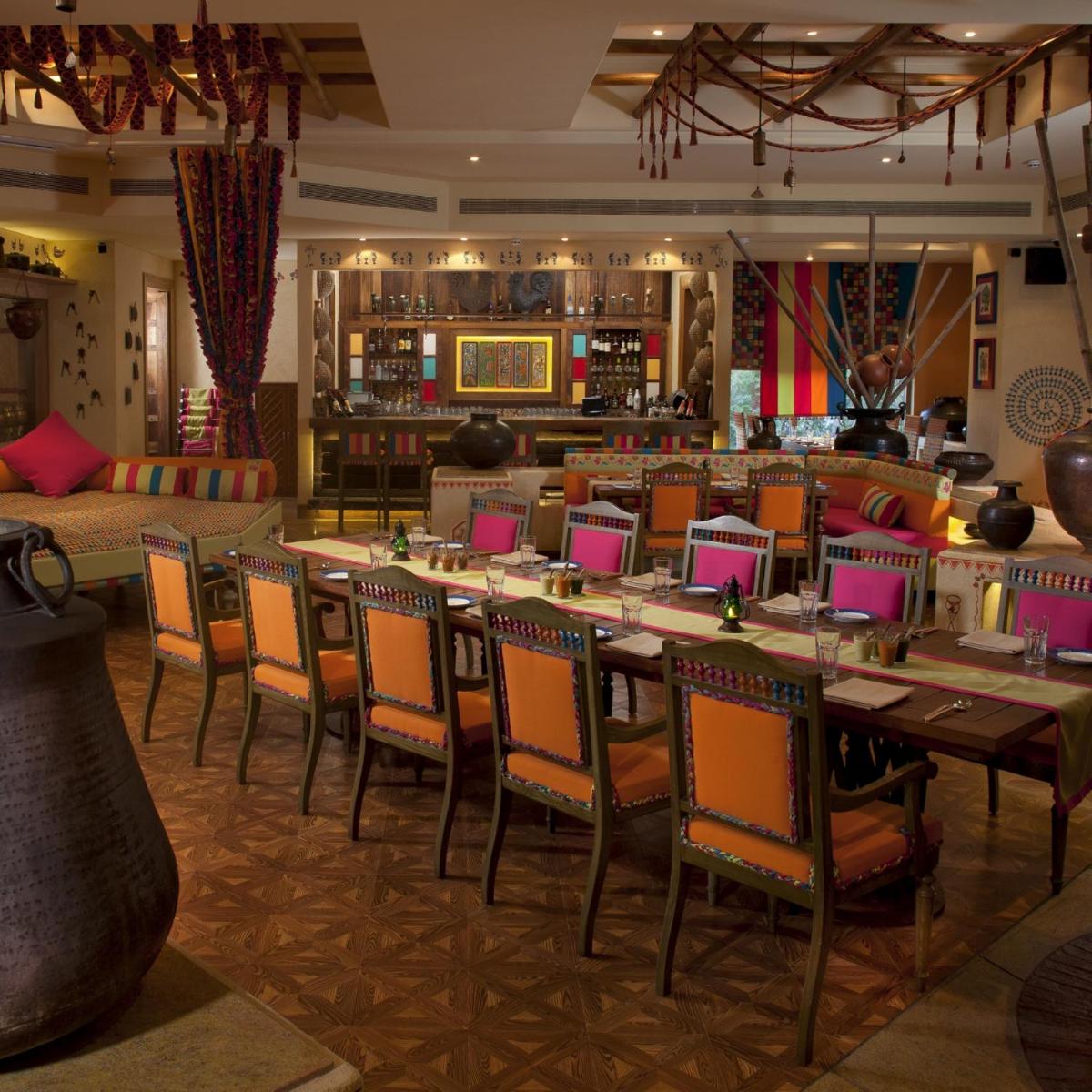 a restaurant with tables and chairs and a bar at Radisson Blu Hotel, Nagpur in Nagpur